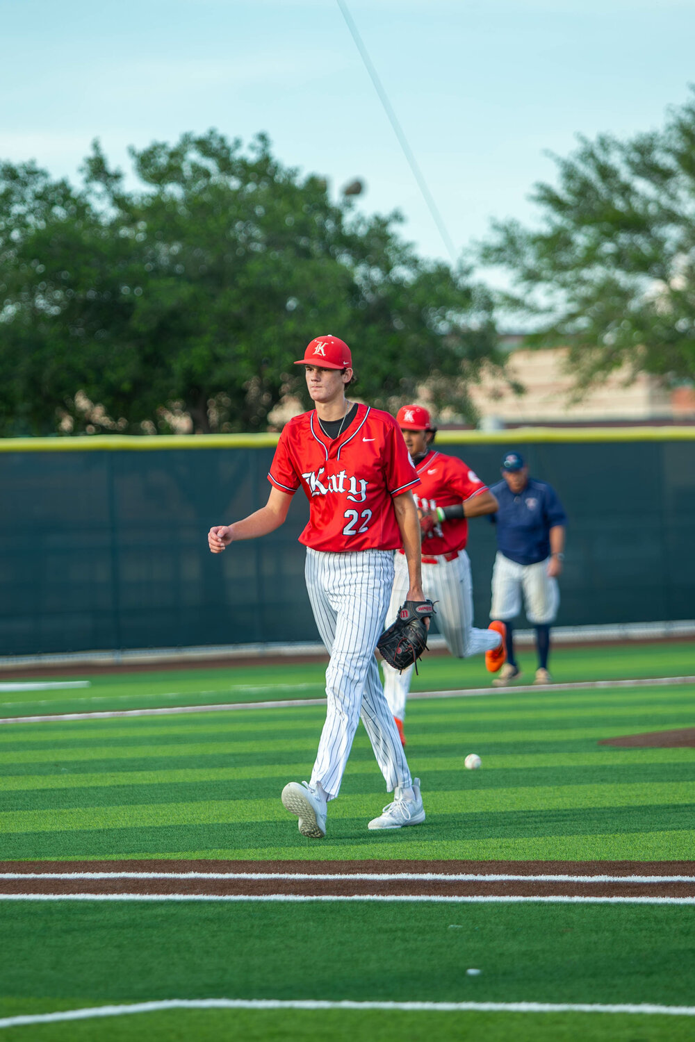 Cade Nelson walks off the field after an inning during Saturday's Regional Quarterfinal between Katy and Tompkins at Cy-Springs.